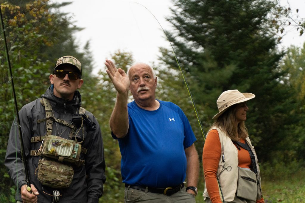 A fly fishing guide talks to clients about their approach
