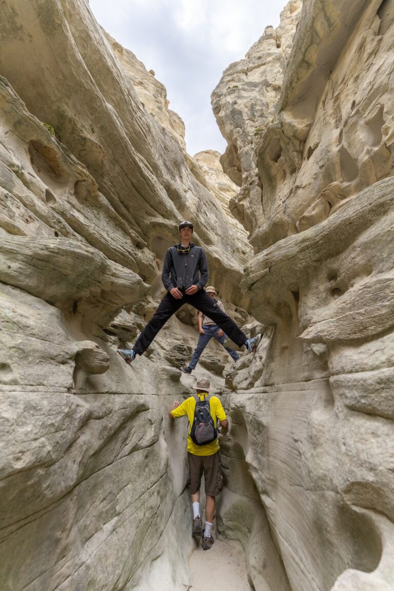 A group heads through a narrow gap between cliffs