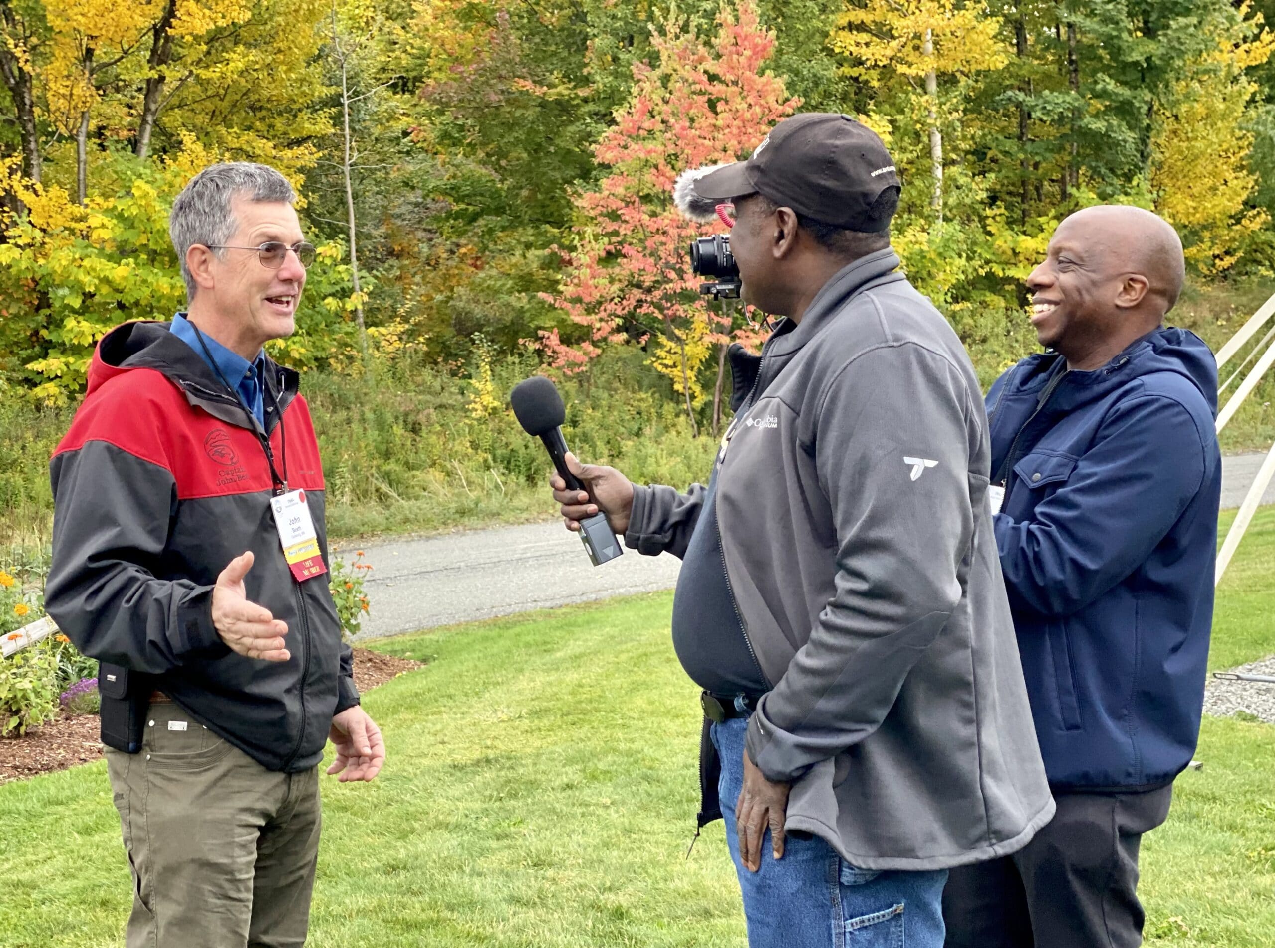 Two media members interview an Outdoor Writers Association conference attendee in Vermont