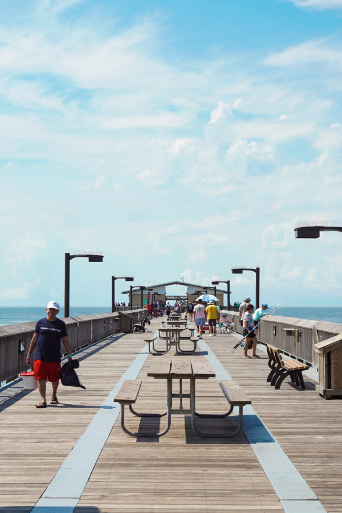 Image of 1. Gulf State Park Fishing and Education Pier with people and fishing poles