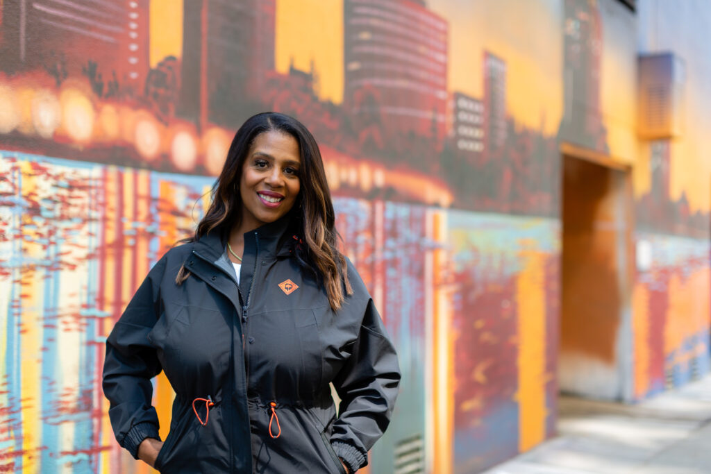 Rue Mapp stands in front of a city scene