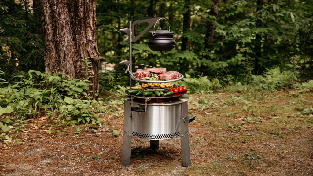 Breeo Y Series fire pit with cooking accessories and food. 