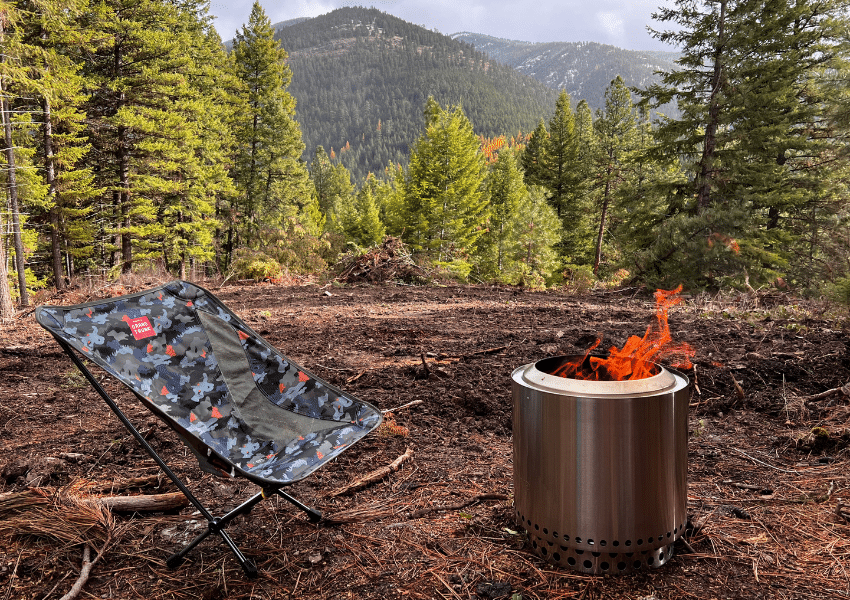 Grand Trunk Mantis Chair sitting next to a fire in the mountains