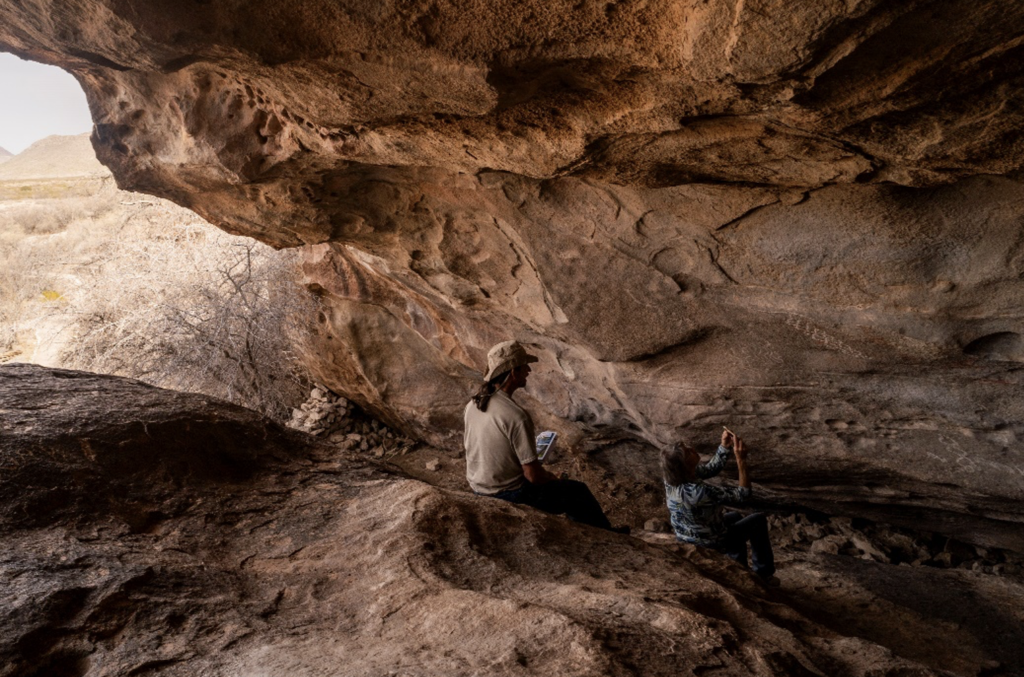 Cave near El Paso, Texas with two people sitting inside
