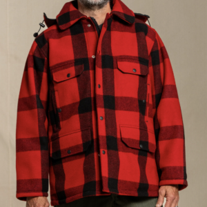 Man wearing a bright red and black plaid Johnson Woolen Mills - 100% Wool Traditional Mackinaw wool coat. 